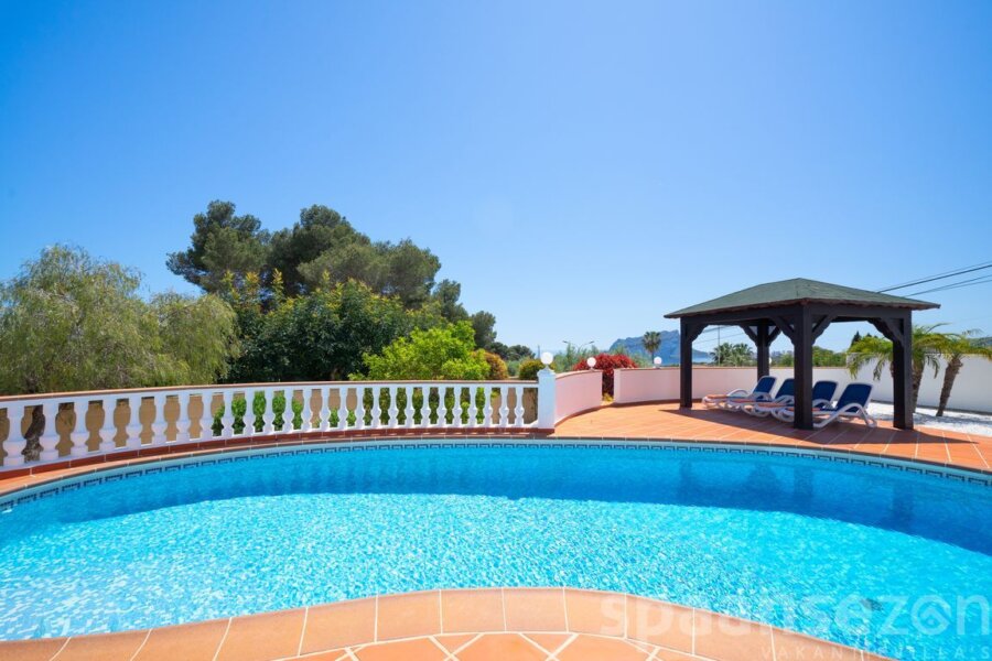 Schwimmbad umgeben von einer großen Terrasse mit Sonnenliegen